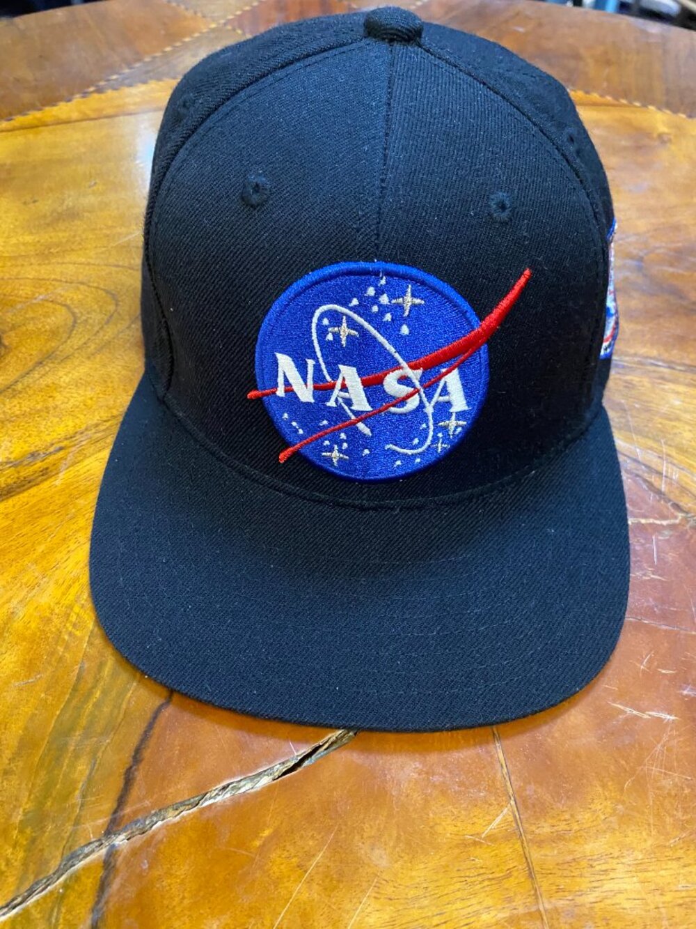 Black flat-brim snapback cap featuring the classic embroidered NASA